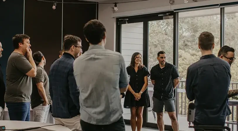 group standing looking at a whiteboard.